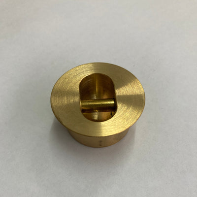 A brass leash plug for surfboards 
